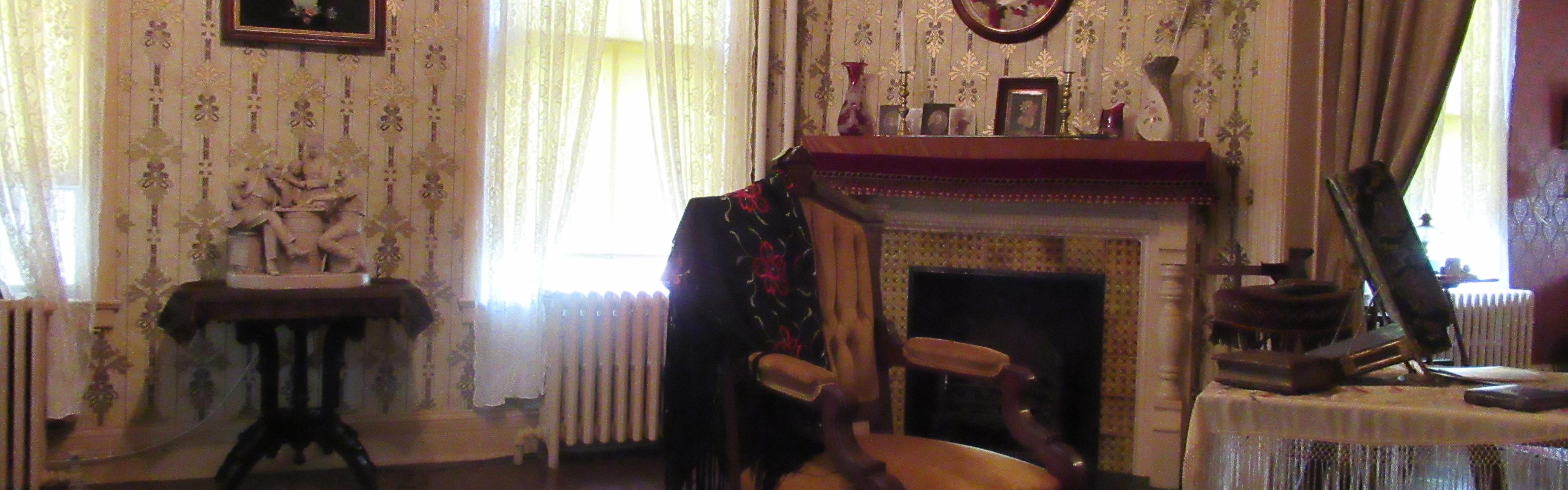 Sitting room with furniture, wall paper, and piano