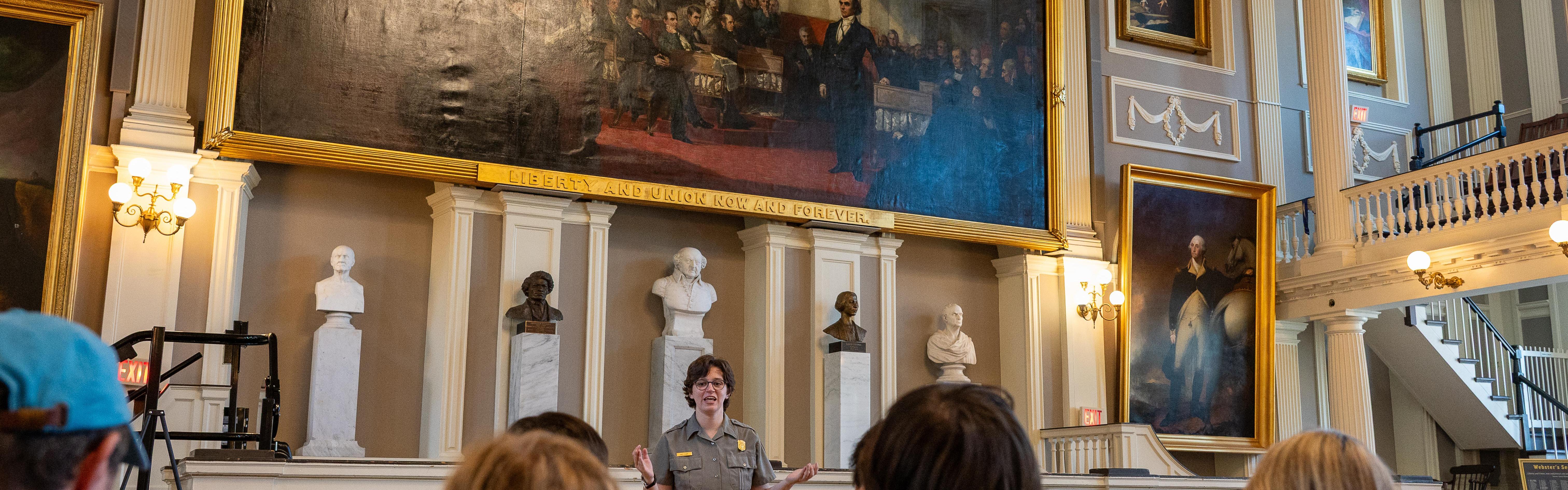 Ranger talking to a group of people in the Great Hall of Faneuil Hall