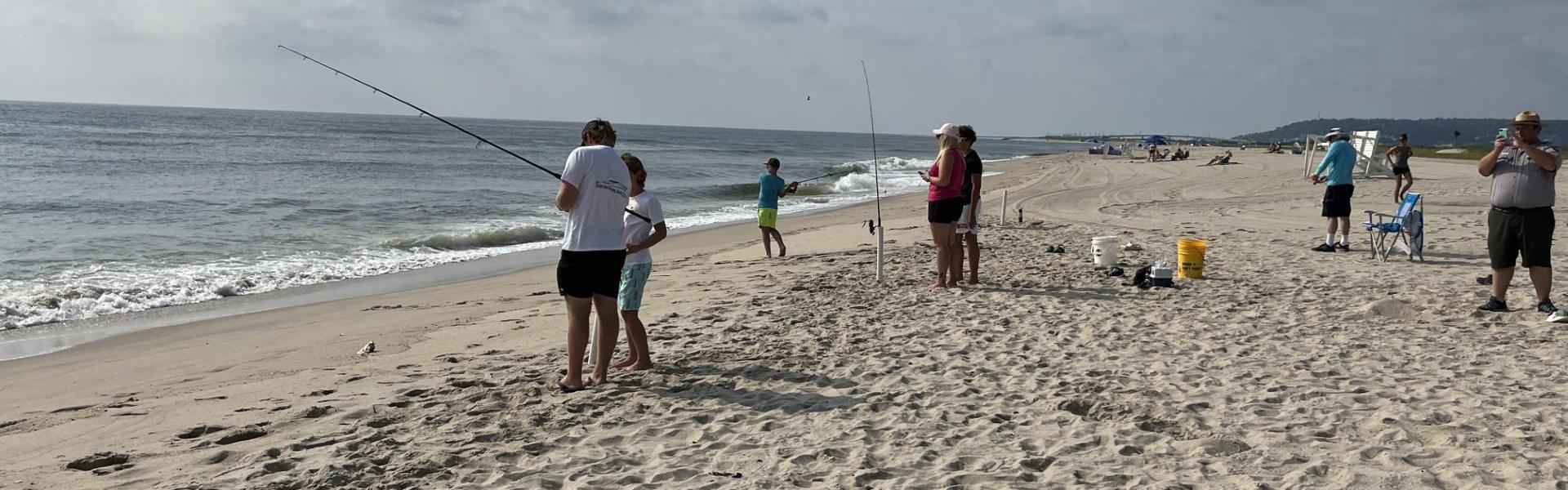 Group of people fishing on the beach