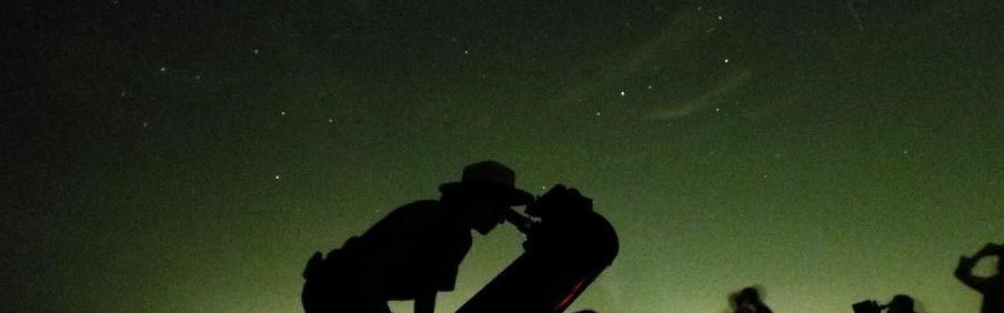 Shadow of ranger looking through telescope