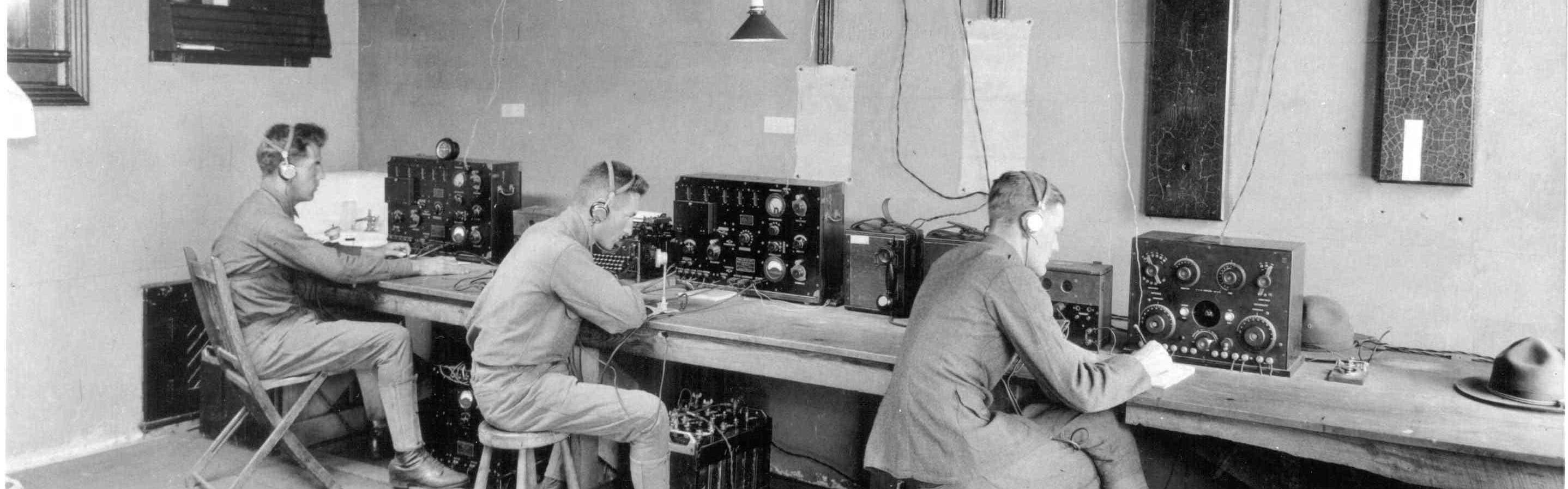 Three soldiers operating radio system