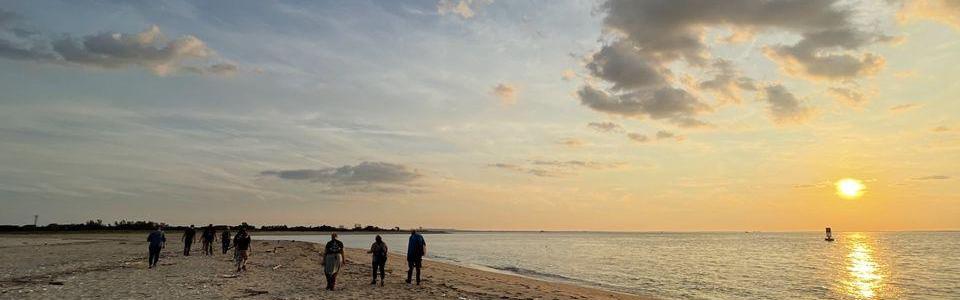 Group of people hiking on sand