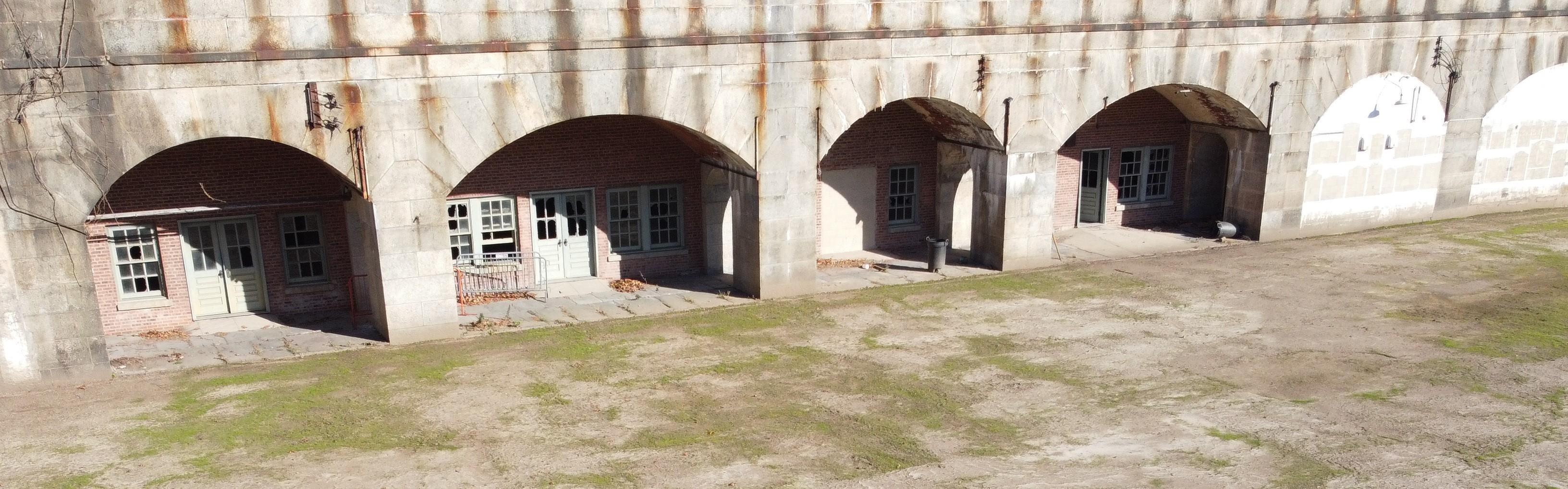 Interior of fort with curved doors and parade ground.