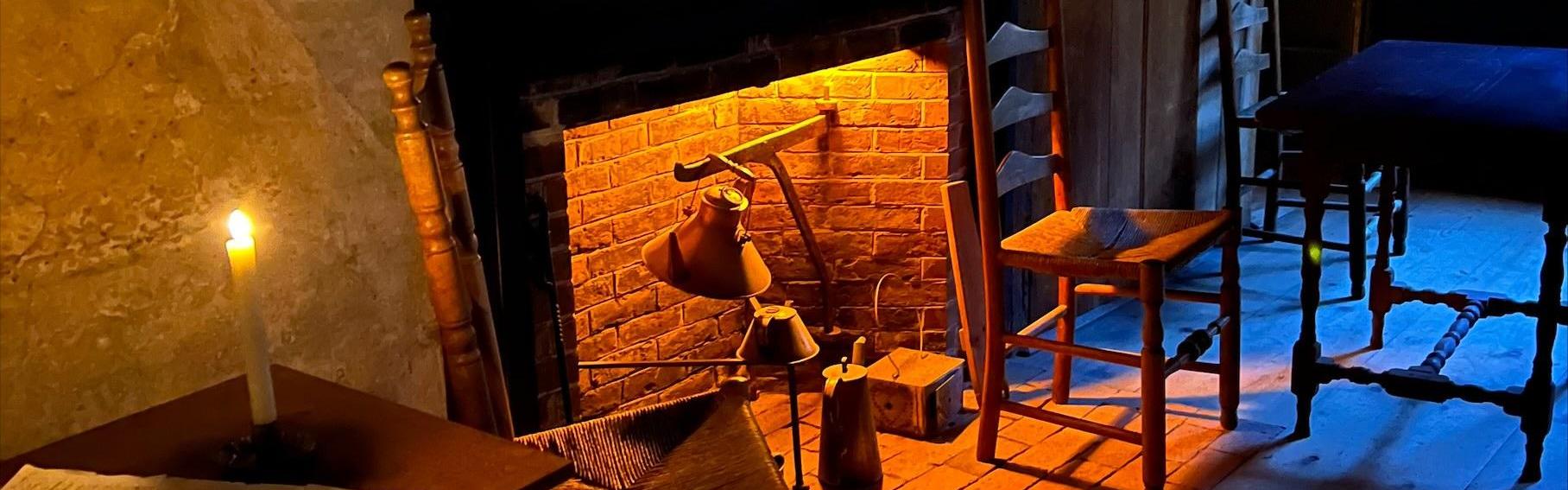 A tavern interior with candles and a fireplace