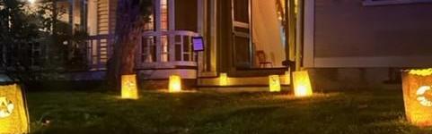 The wayside front door with luminary bags leading to it.