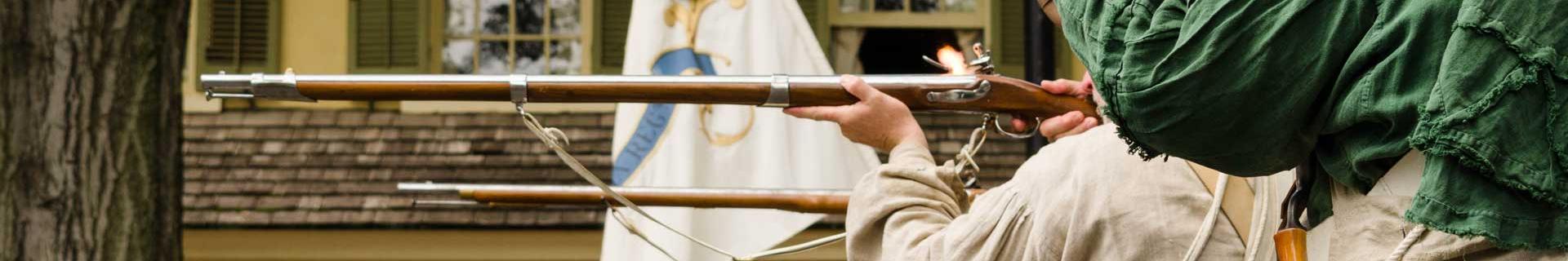 Re-enactors ready their weapons for a volley