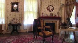 Sitting room with furniture, wall paper, and piano