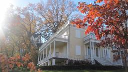 A large light-colored house with white detailing.
