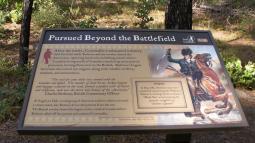 Image of the park sign at Rugeley's Mill State Park with the title  "Pursued Beyond the Battlefield"