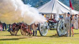 A connon being fired at Historic Camden Revolutionary War Field Days