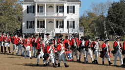 British re-enactors marching in front of the Kershwaw-Cornwallis house in Historic Camden