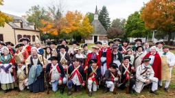 Living historians posing for a photo in front of the East Jersey Old Town Village