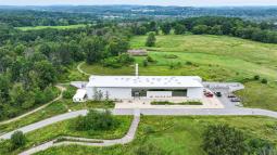 Aerial shot of Ganondaga State Historic Site with museum and longhouse in view