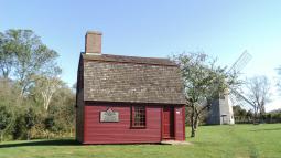 Red wooden building used as headquarters for General Prescott