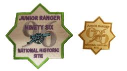 Both the embroidered Junior Ranger patch and the wooden badge are in the shape of an 8-pointed star.