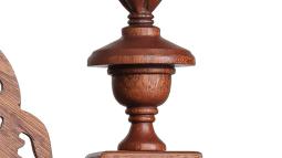 a close up photograph of detail on a carved wooden chair