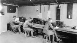 Three soldiers operating radio system