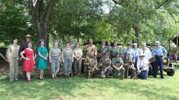 Large group of WWII-era living historians pose for a picture