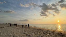 Group of people hiking on sand