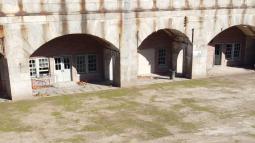 Interior of fort with curved doors and parade ground.