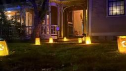 The wayside front door with luminary bags leading to it.