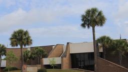 outside view of brick Fort Moultrie visitor center with entrance sign