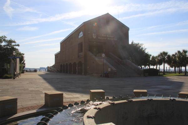 Outside view of visitor center, three-stories, brick with fountain in the foreground