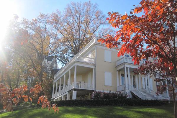 A large light-colored house with white detailing.