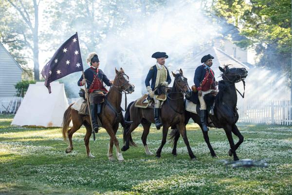 Revolutionary War reenactment showing three riders on horses