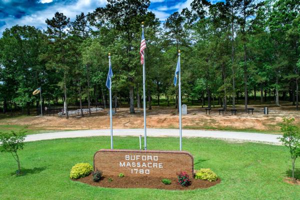 Image of the entrance memorial sign and flags denoting Buford Massacre 1780