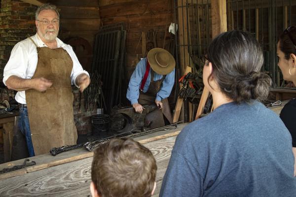 Blacksmith talking to a tour group