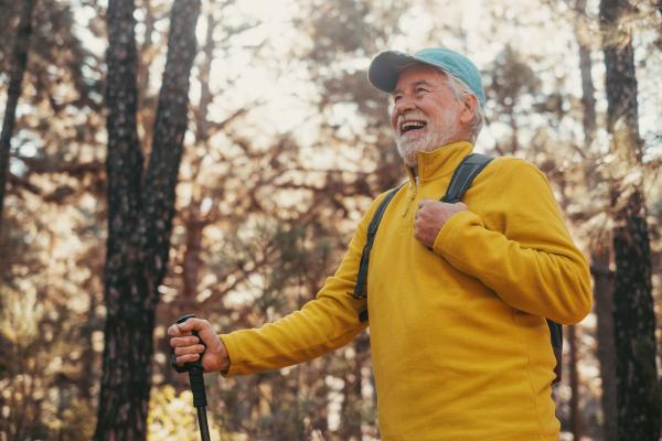 Image of an older man hiking in the woods