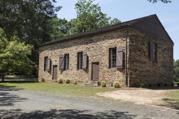 Image of a brown brick building, brown shutters and a brown roof