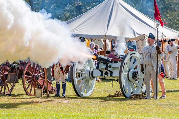 A connon being fired at Historic Camden Revolutionary War Field Days