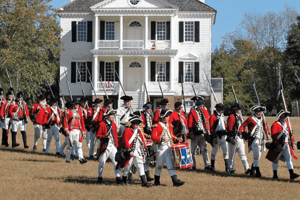 British re-enactors marching in front of the Kershwaw-Cornwallis house in Historic Camden