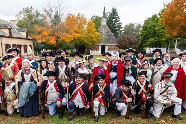 Living historians posing for a photo in front of the East Jersey Old Town Village