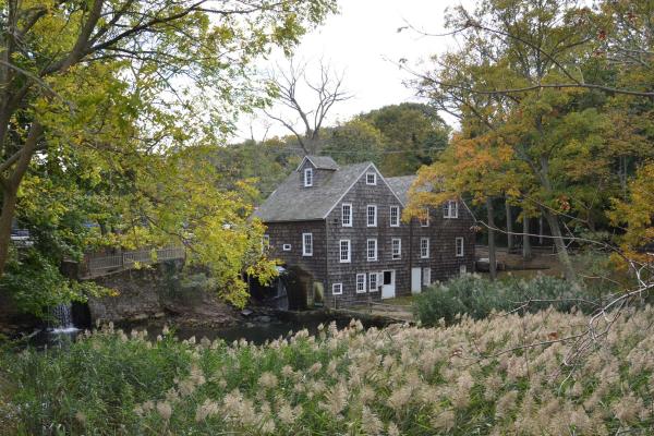 Scenic photograph of the Stony Brook Grist Mill alongside a creek