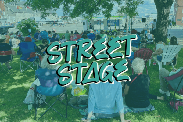 Street Stage graphic with a photo of people sitting on a lawn watching a performance on a stage.