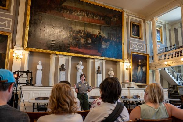 Ranger talking to a group of people in the Great Hall of Faneuil Hall
