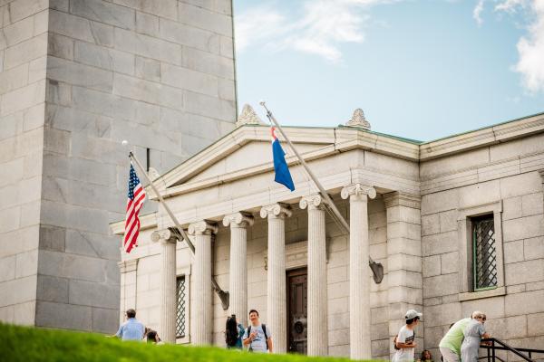A white granite building next to the Bunker Hill Monument