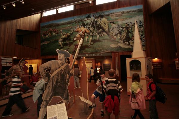 Children in the visitor center lobby exploring Revolutionary War-related exhibits