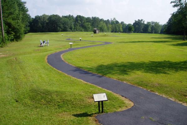 The walking trail winds past a cannon and a rifle tower.