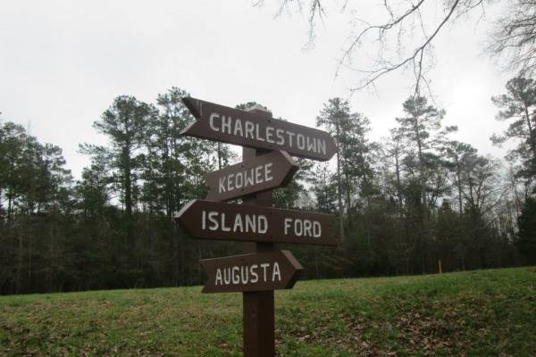 A wooden sign shows the direction of important places in 1781.