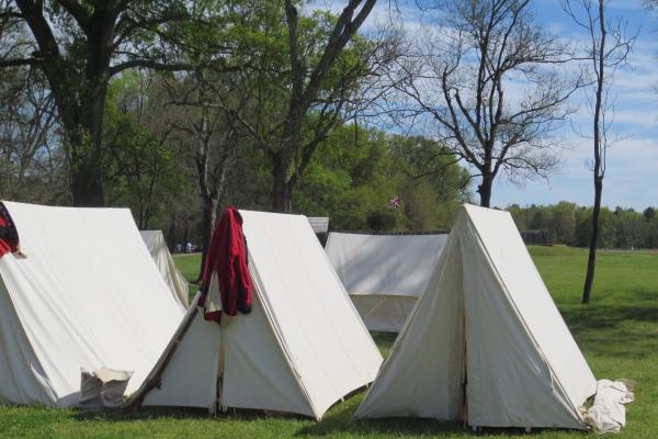 A British regimental coat hangs on a tent.