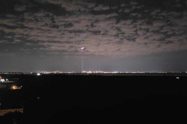 Two beams of light shining into sky