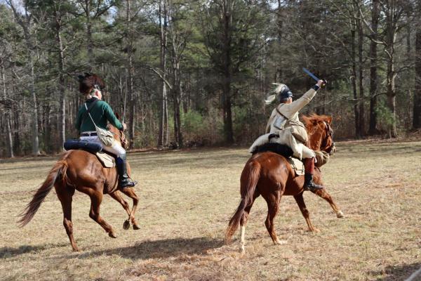 Two reenactors on horseback