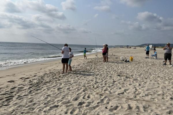 People fishing on the beach