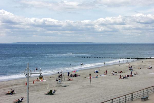 Visitors enjoying the sun and sand at Jacob Riis Park