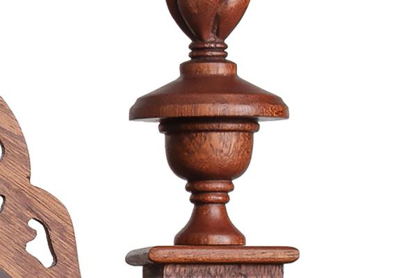 a close up photograph of detail on a carved wooden chair