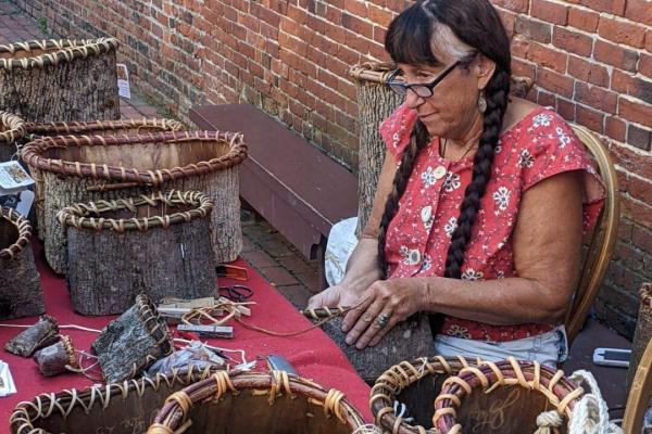 Jennifer Lee demonstrates bark basket weaving in the Revere House courtyard
